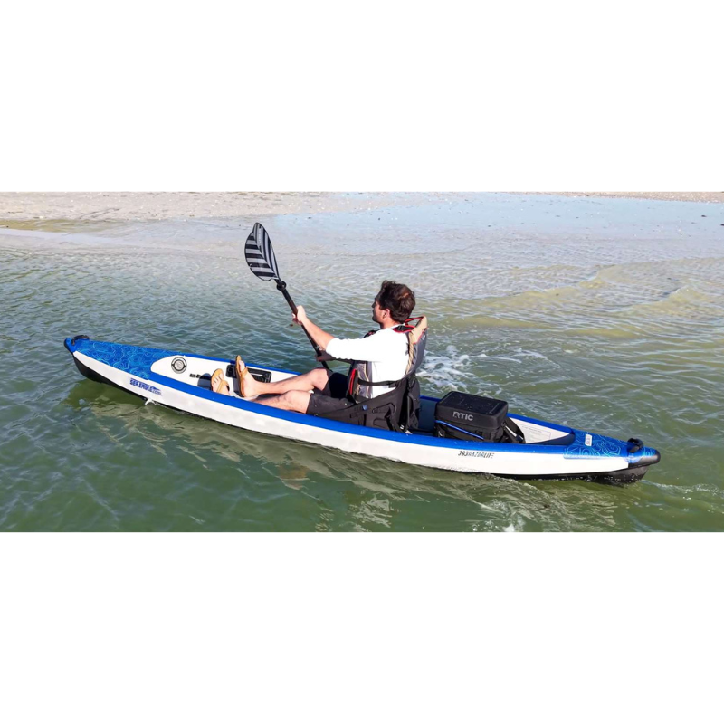 Sea Eagle RazorLite 393RL Inflatable Kayak Person paddling a blue and white kayak on calm water